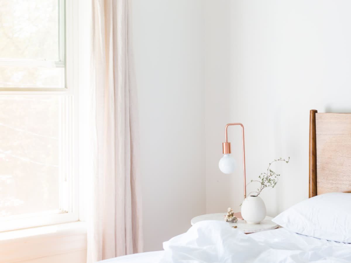 A made bed in a bright bedroom